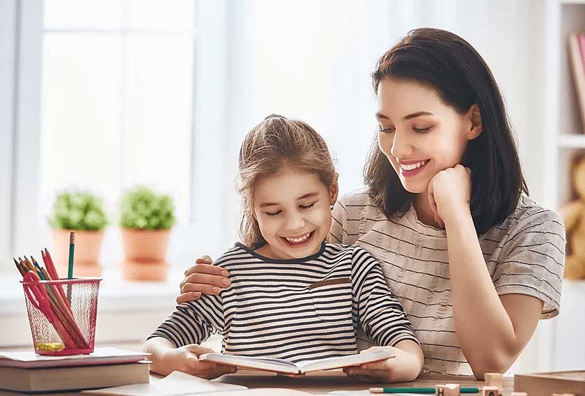 Therapist working with young girl on speech articulation