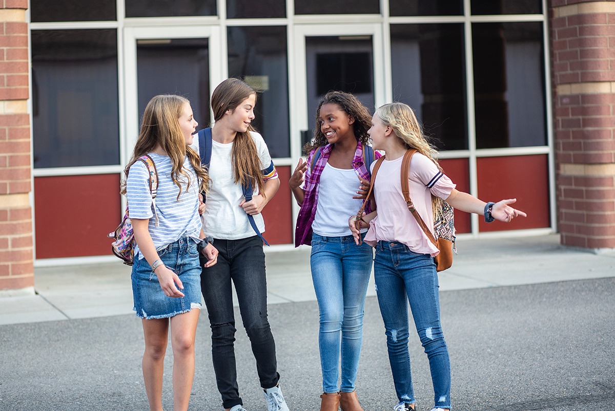 Teenage Girls Talking outside of a School 