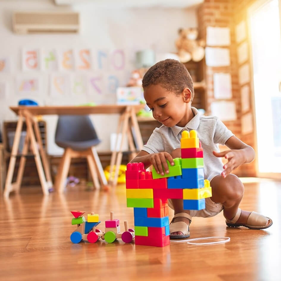 Boy Playing With Colorful Blocks