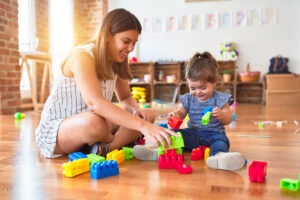 Therapist Playing With Child Using Stacking Blocks
