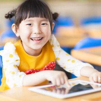 School Aged Girl utilizing AAC Device