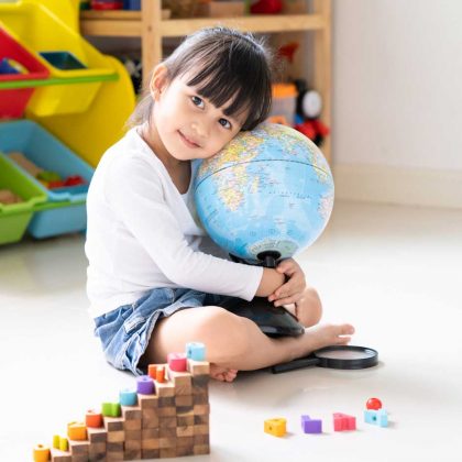 Bilingual Child Holding Globe