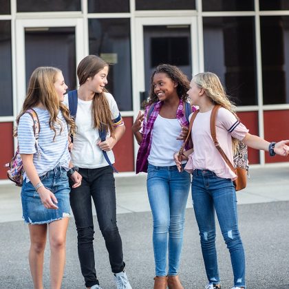 Teenage Girls Talking outside of a School