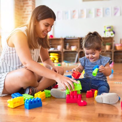 Therapist Playing With Child Using Stacking Blocks