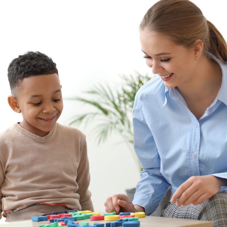 Young Boy Working With Speech Therapist
